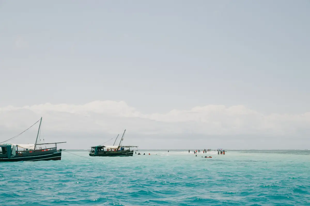 Traditional fishing boats anchored in turquoise coastal waters