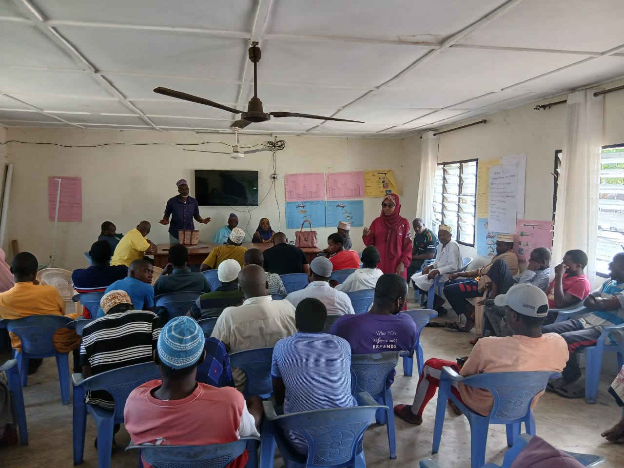 Community members gathered at a village awareness forum